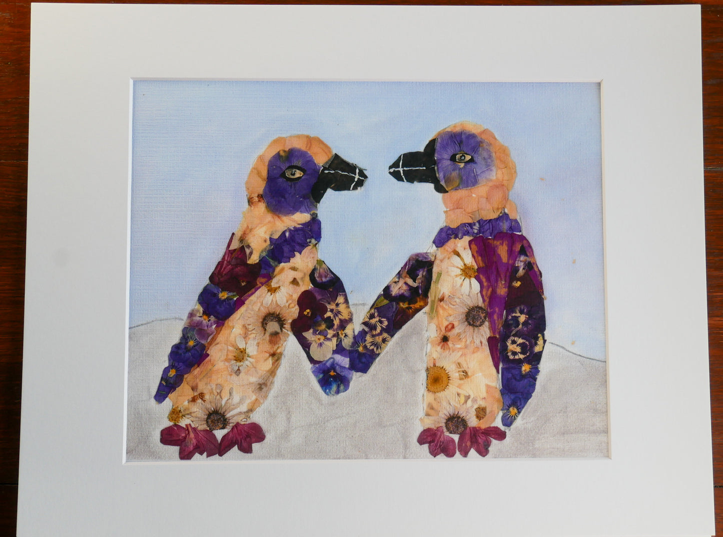 The image is a collage of two pictures, each featuring a bird-like creature with a flower-like body. The creatures are wearing colorful clothing and have flower-like patterns on their bodies.