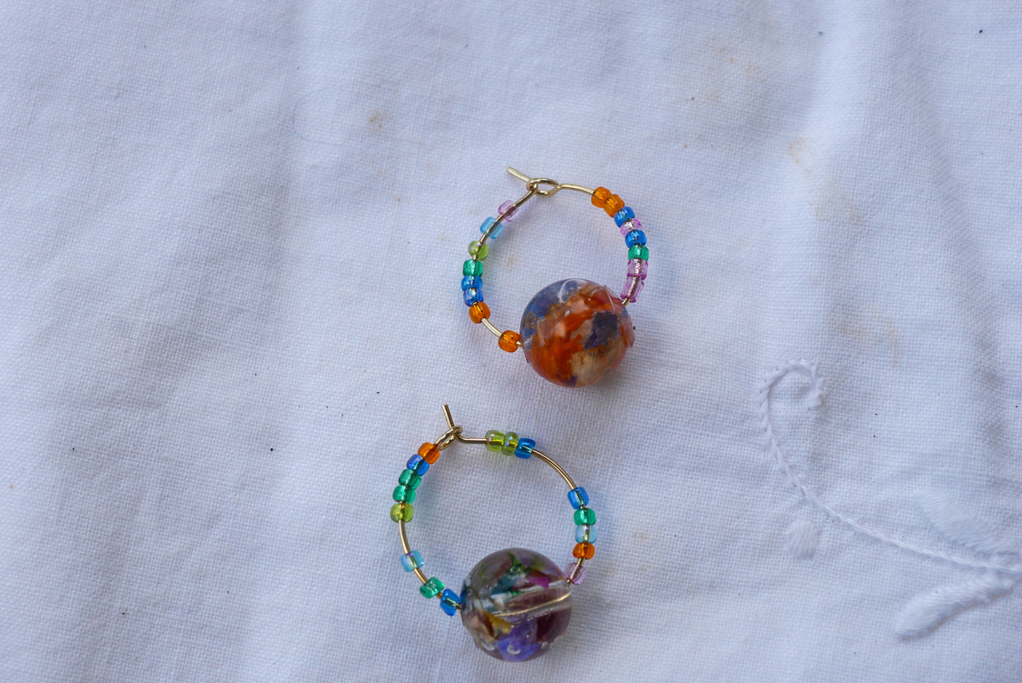 Stainless Steel Huggy Hoops with Baby’s Breath Heart Charms