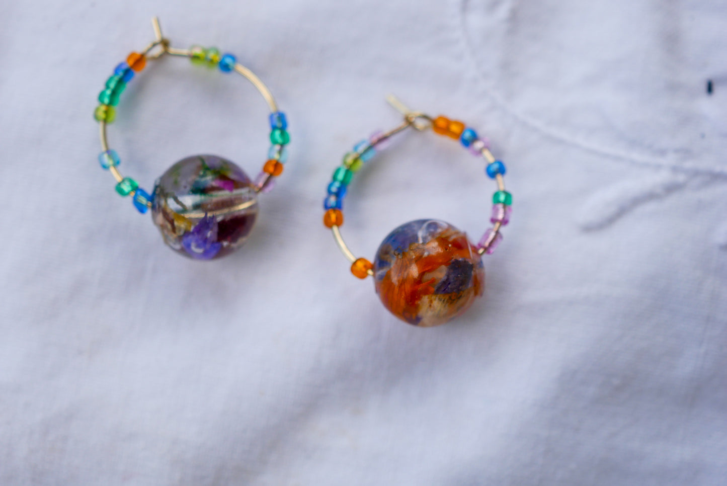 Stainless Steel Huggy Hoops with Baby’s Breath Heart Charms
