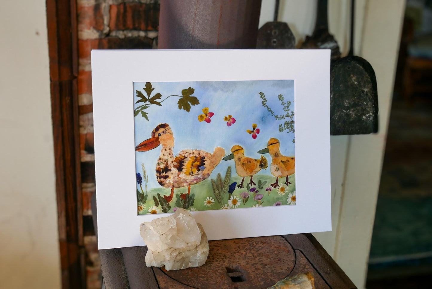 a vibrant painting of a family of ducks in a lush green field, surrounded by colorful flowers and plants.