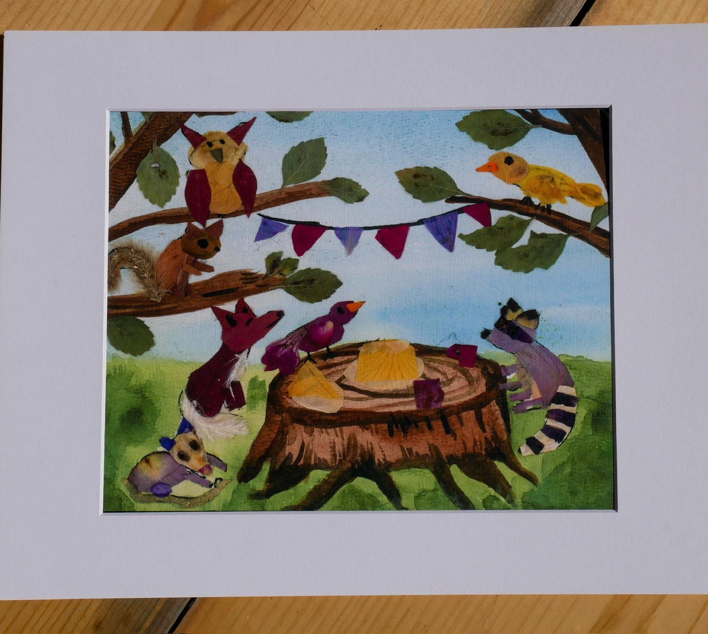 A collage of various animals, including a bird, squirrel, raccoon, and deer, gathered around a tree stump with a yellow object on it, set against a backdrop of leaves and a blue sky.