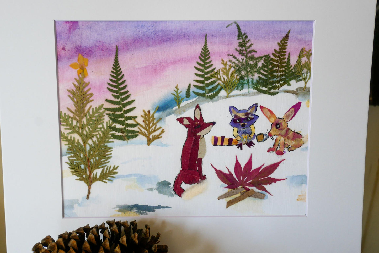 The image is a watercolor painting depicting a snowy forest scene with various animals, including a fox, a rabbit, and a bird, interacting with each other.