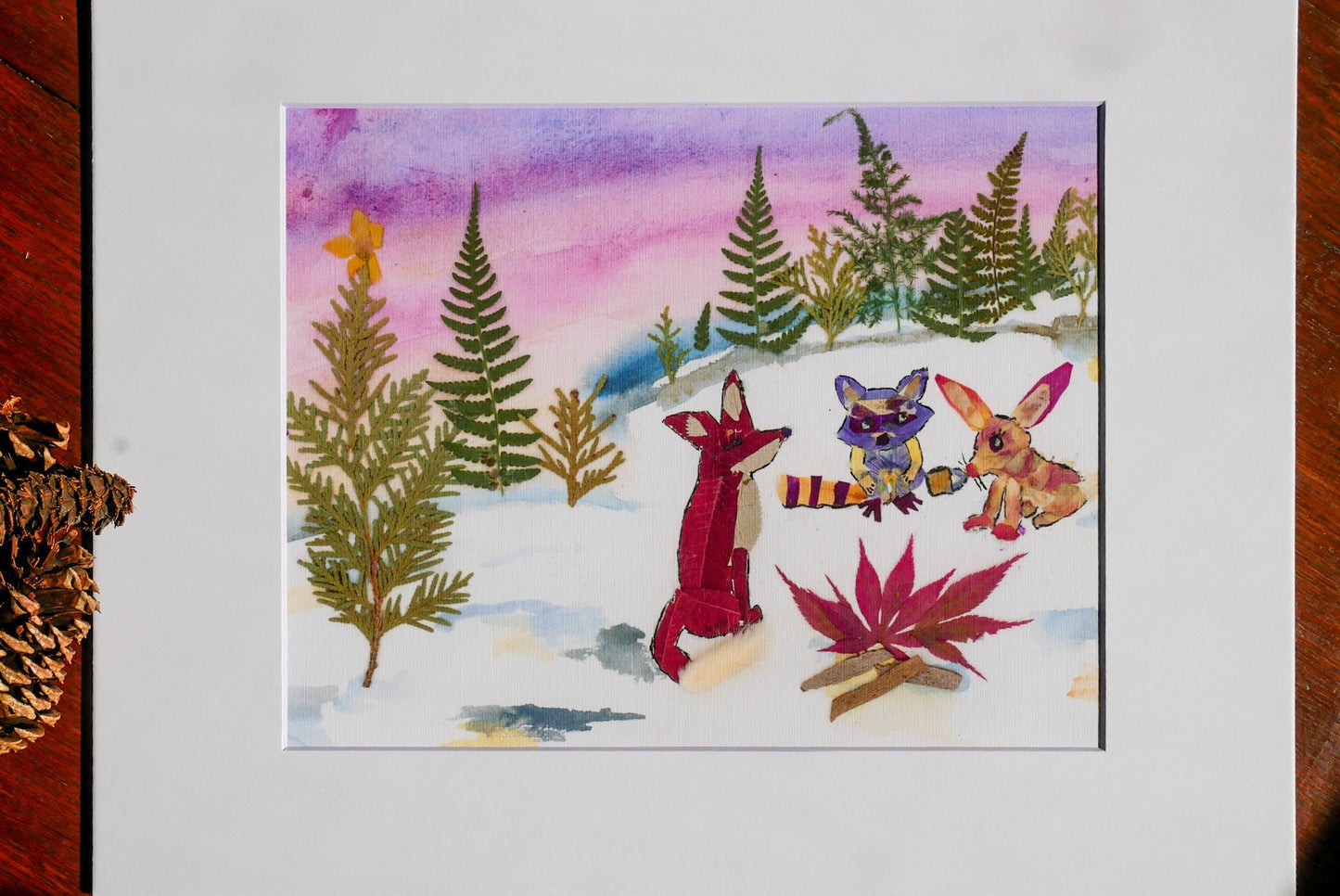 A vibrant watercolor painting depicting a snowy forest scene with three cartoon animals - a fox, a rabbit, and a raccoon - sitting on the snow and surrounded by pine trees and a colorful sky.