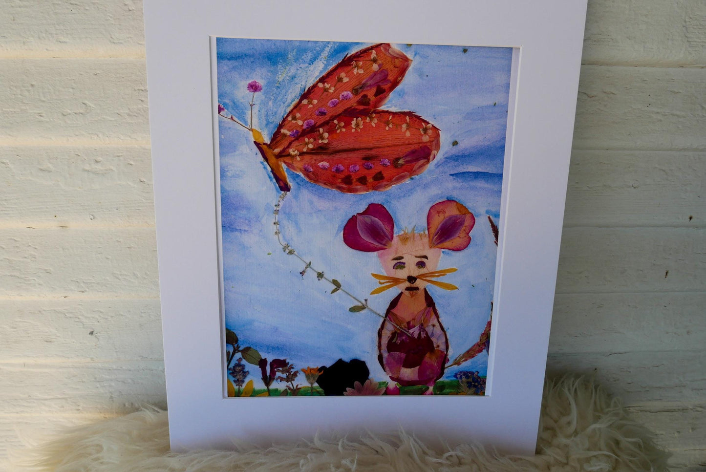 The image is a framed artwork depicting a butterfly and a mouse in a whimsical, colorful scene.