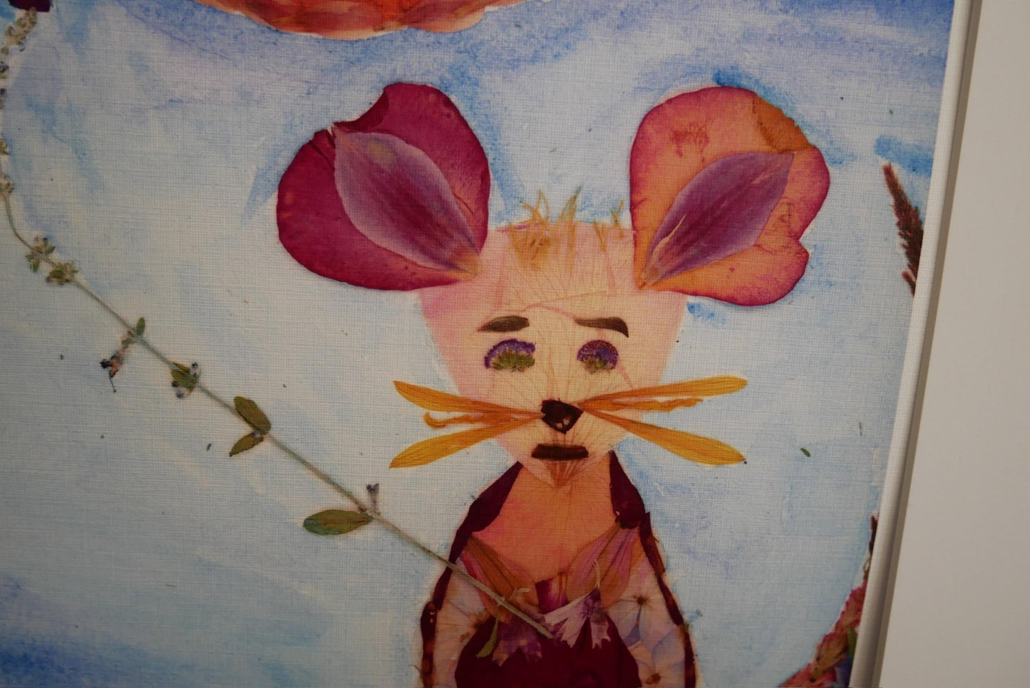 The image is a collage featuring a colorful, hand-painted rabbit with large, vibrant flower petals on its ears.