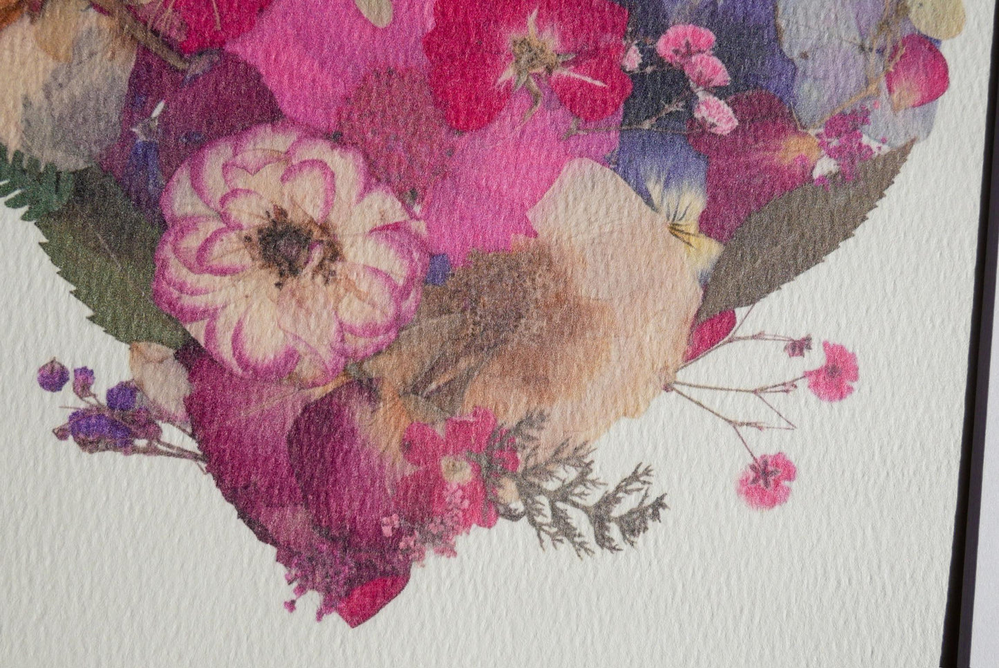 The image is a close-up of a vibrant and colorful floral arrangement, featuring a variety of flowers in shades of pink, purple, and yellow.