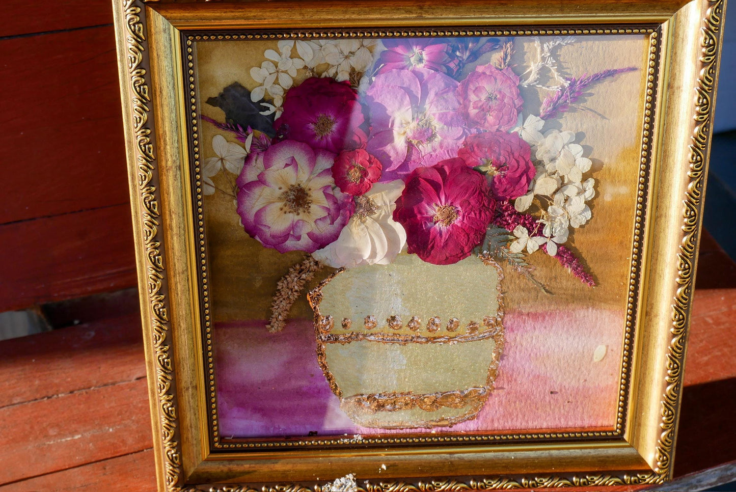 a framed painting of a vase filled with a variety of colorful flowers, including pink, white, and purple blooms.