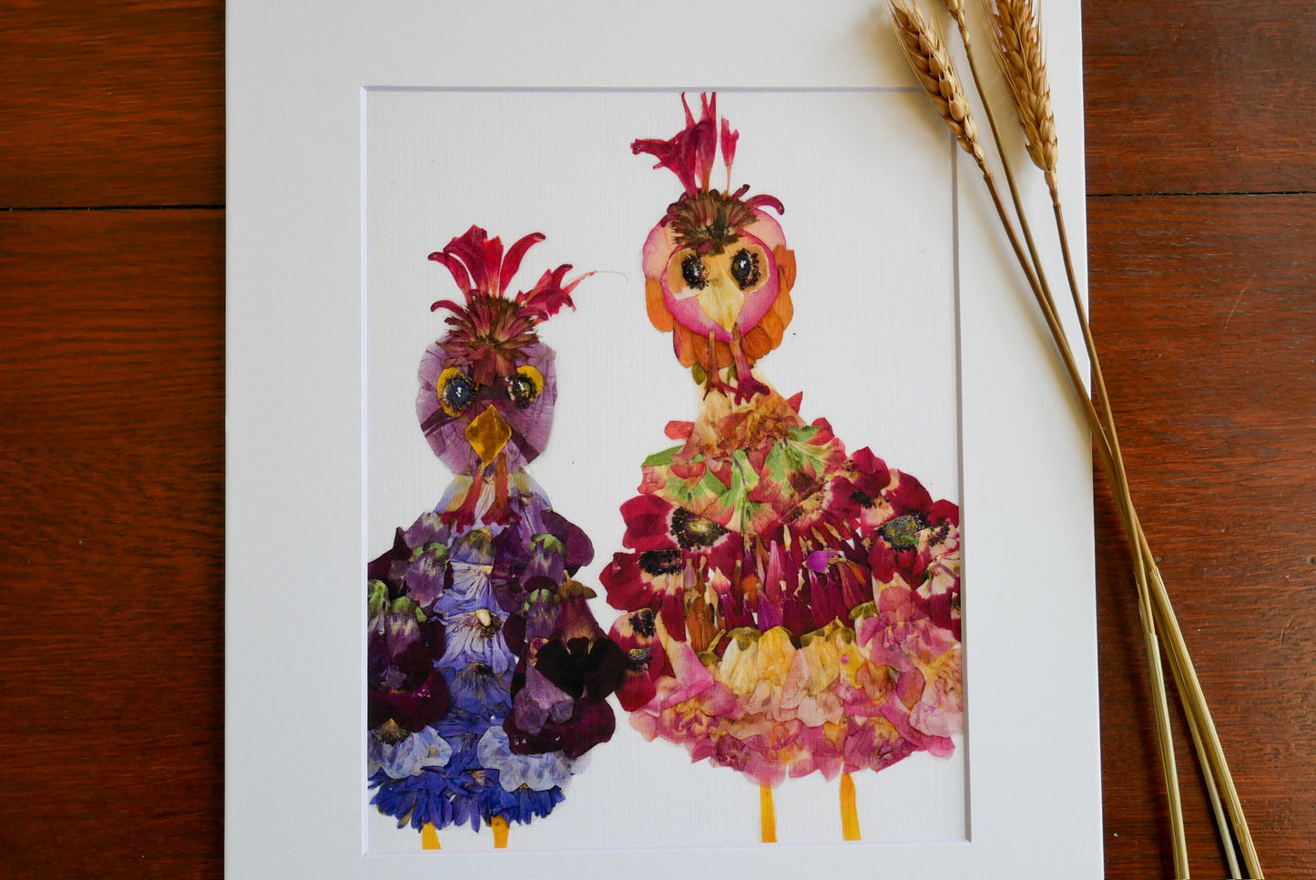 two colorful, flower-like creatures standing next to each other, with vibrant petals and intricate patterns.