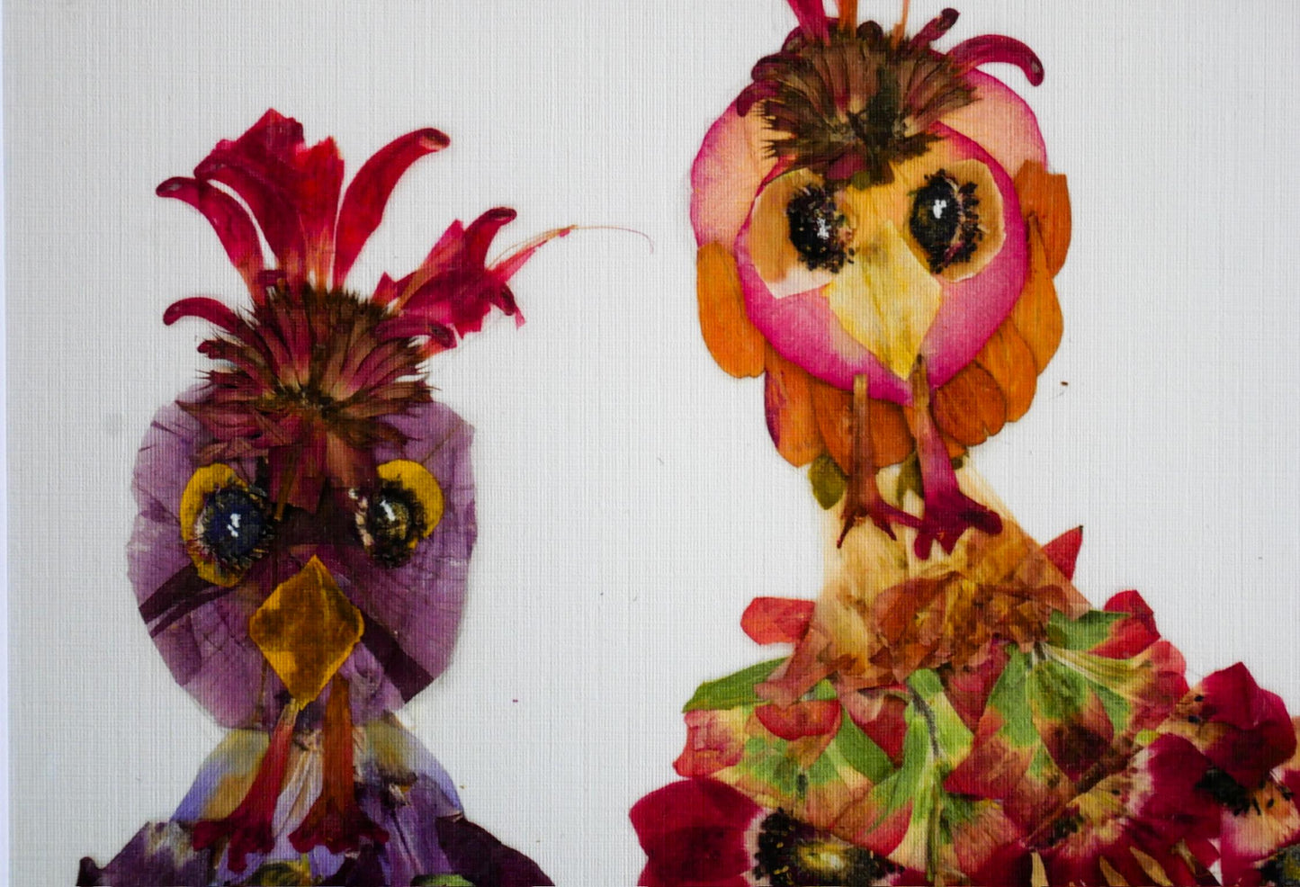 two colorful, flower-like creatures made from leaves and petals, with one being a bird and the other a dragon.