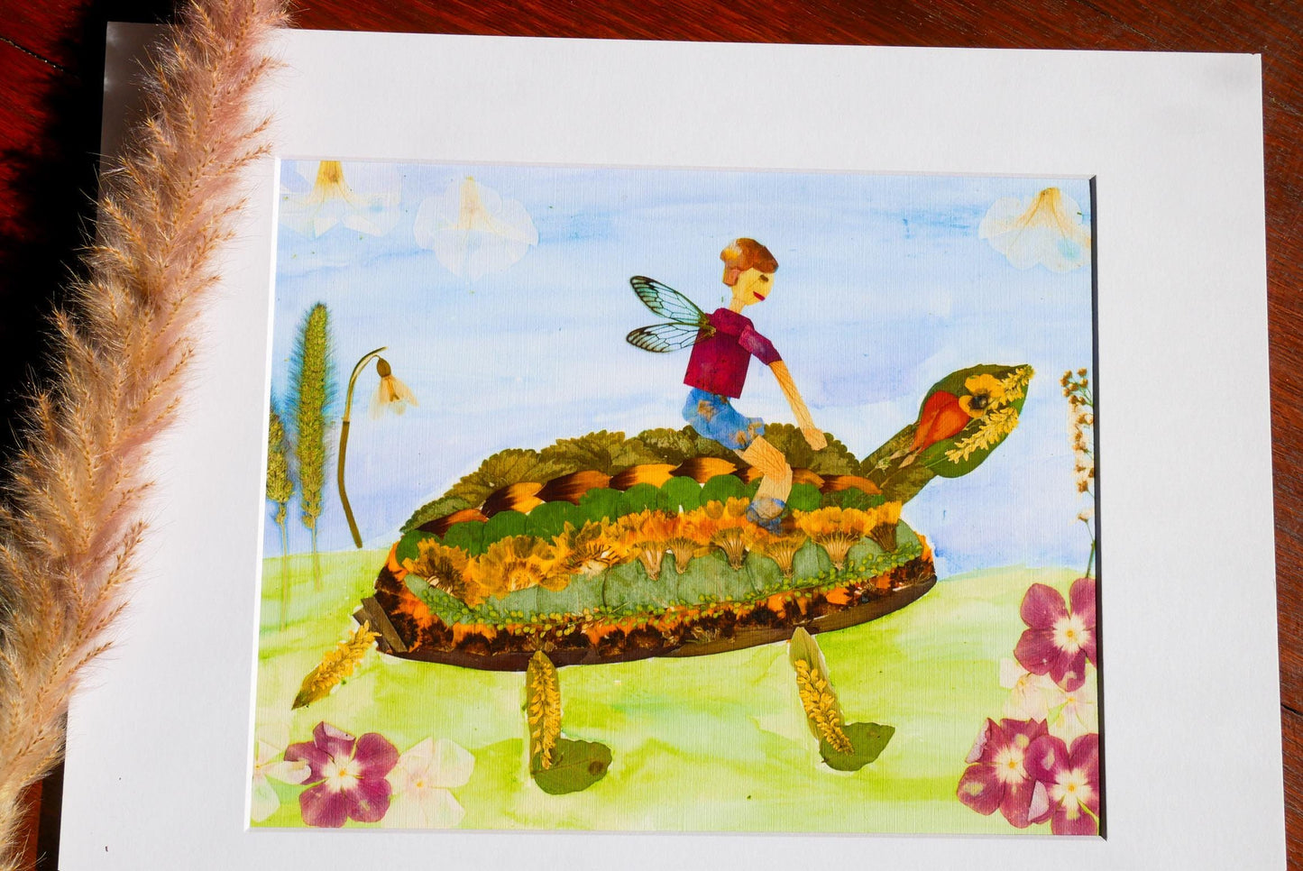 A collage of various images, including a person riding a turtle, flowers, and a fairy, all set against a blue sky background.